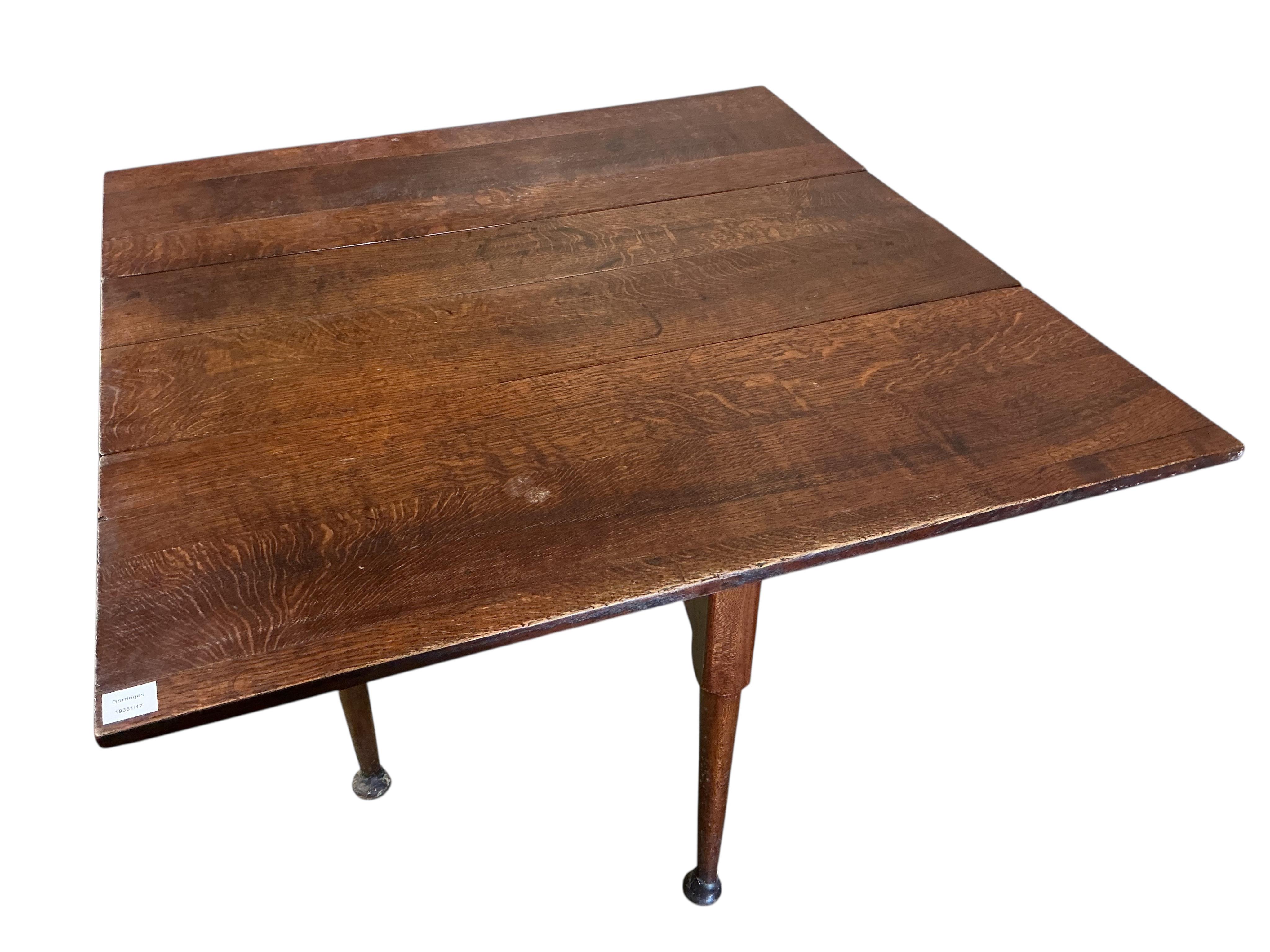 A George III oak drop leaf dining table, width 112cm, depth 42cm, height 71cm together with four George III Provincial mahogany wood seat dining chairs